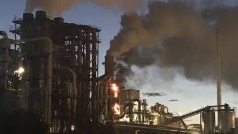 Mark Roberts Smoke and flames coming from part of the Kronospan factory in Chirk