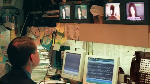 AFP/Getty Images Reporter watches Monica Lewinsky's testimony - 6 February 1999