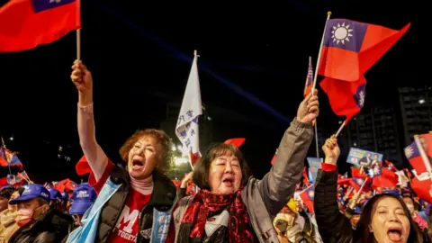 Getty Images Supporters wave flags during KMT rally