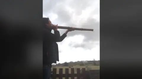 The Belper Moo Resident uses a didgeridoo