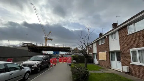Shaun Whitmore/BBC House with damaged window near blast site