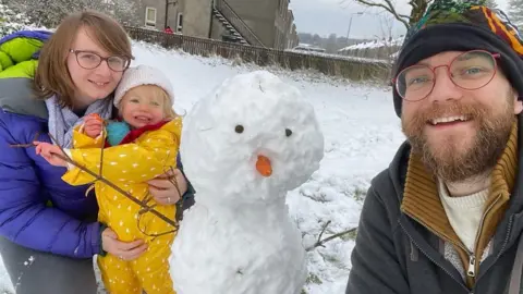 Dogs and children have been playing in the wintry conditions after waking up to snow.