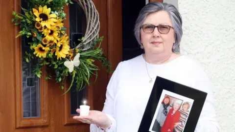 Pacemaker Brenda Doherty with a photo of her mum Ruth Burke
