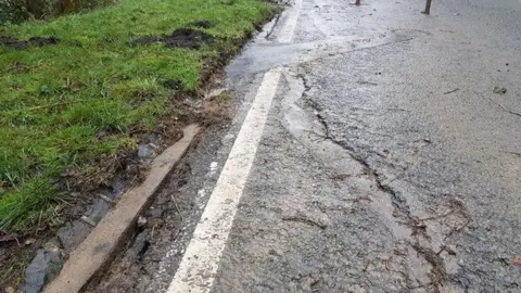 Gloucestershire County Council Charlton Hill in Cheltenham with cracks in the road