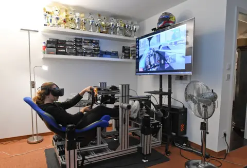 Andreas Gebert / REUTERS Formula 3 racer Sophia Floersch uses a virtual-reality simulator at home