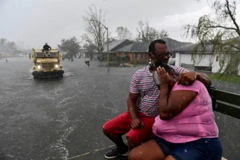 Getty Images Couple huddling together in hurricane