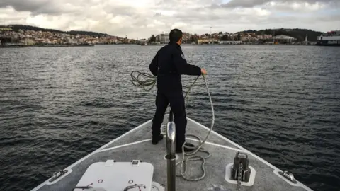 Getty Images The Greek coast guard arrives at the port of Mytilene after patrolling on the Mediterranean sea between the Greek island of Lesbos and Turkey, 19 March 2019