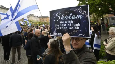 EPA-EFE/REX/Shutterstock A man holds up a sign in support of Eden Golan