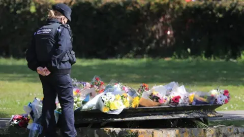 PA Media Floral tributes