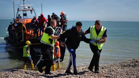 PA Media Migrants arriving at Dungeness