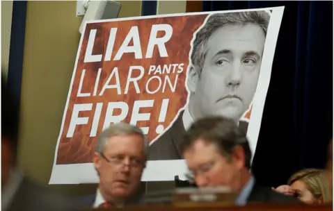Reuters Congressman Paul Gosar held up a large sign with "Liar, Liar, Pants on Fire!!" emblazoned over a picture of Michael Cohen.