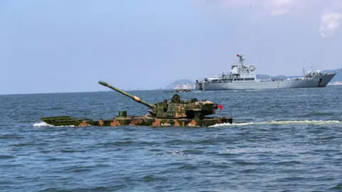 Getty Images brigade of the army under the Eastern Theater Command and a department of the Navy carry out a multi-subject combat training in a sea area in Zhangzhou, Fujian province, China, Aug 27, 2022