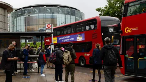 SOPA Images/Getty People queuing for a Go-Ahead bus in Waterloo