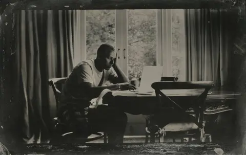 Jo de Banzie Man on a computer