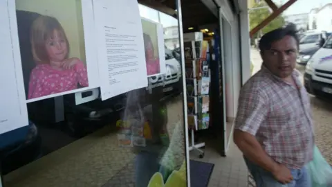 AFP Photographs of Madeleine McCann are pasted onto a shop front on 4 May 2007 in the area of the Ocean Club apartment hotel in Praia da Luz in Portugal