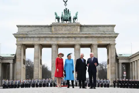 Reuters German President Frank-Walter Steinmeier, his wife Elke Buedenbender and Britain's King Charles and Camilla, the Queen Consort attend a welcome ceremony with military honours at Pariser Platz square in front of Brandenburg Gate in Berlin