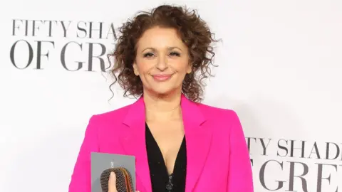 Getty Images Nadia Sawalha poses on red carpet