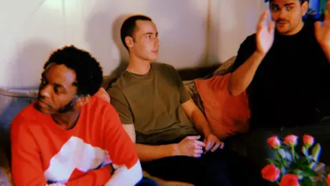 SLEEC Three people talking on a sofa