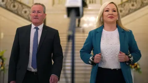 Brian Lawless/PA Michelle O'Neill, with Finance Minister Conor Murphy, says voters expect members in the chamber