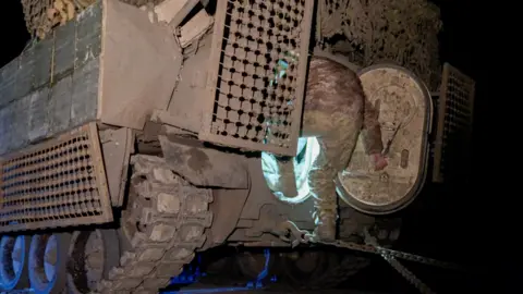 BBC/Matthew Goddard A soldier climbs into the back of a Bradley