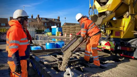 Martin Giles/BBC Concrete laying