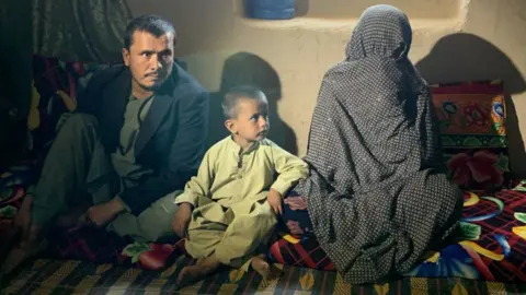 BBC Image shows Shamsullah, his son and his mother Goljuma