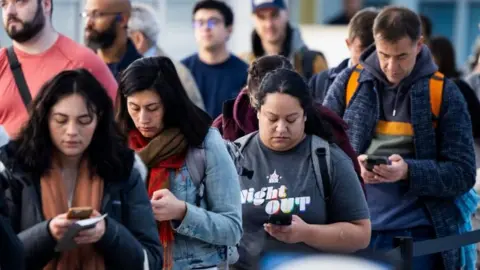 Travellers queue at Dulles airport