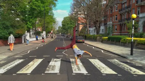 Fernanda Marques Júlio Andrade does a handstand on the Abbey Road crossing.