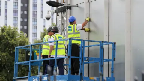 Getty Images File pic of cladding being removed from a building in Salford