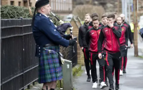PA Media Partick Thistle players attended the funeral service at Partick Burgh Hall