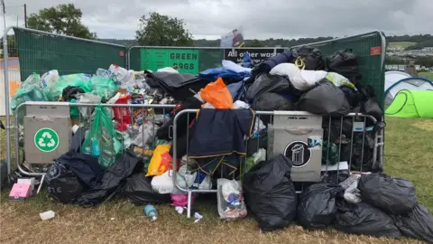 A collection of waste and recyclable items in bins