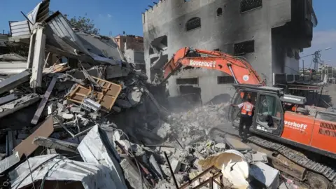 EPA-EFE/REX/Shutterstock Palestinians search for victims and survivors in the rubble of Al-Naqeeb family house leveled in an Israeli airstrike in Al Nusairat, central Gaza Strip, 16 October 2023