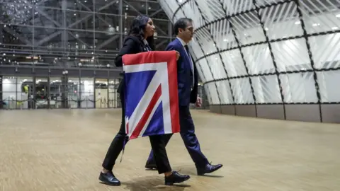 Getty Images EU Council staff members remove the United Kingdom's flag from the European Council building in Brussels on Brexit Day, January 31, 2020