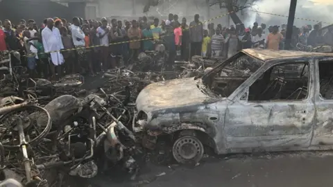 Reuters Freetown residents inspect the remains of cars and motorbikes on Saturday morning