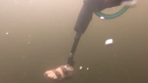 Angus Hosking The prosthetic leg under the water