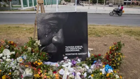 EPA A view of an altar with flowers made as a tribute to President Jovenel Moise, assassinated a week ago at his home; in front of the National Palace in Port-au-Prince, Haiti, 14 July 2021