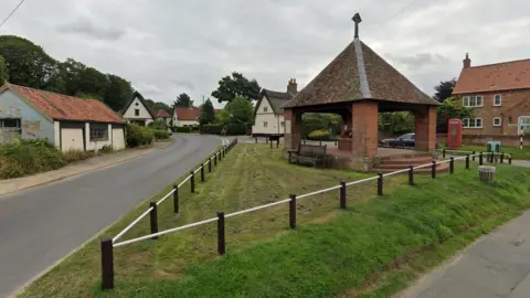 Google View of Saxlingham Nethergate with war memorial, thatched cottages and red phone box