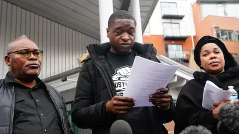 PA Media Chris Kaba's family speaking outside the inquest