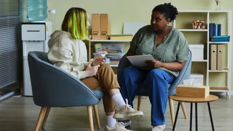 Getty Images picture of young adult speaking to advisor