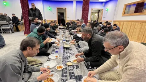 Worshippers at Husaini Islamic Centre eating together