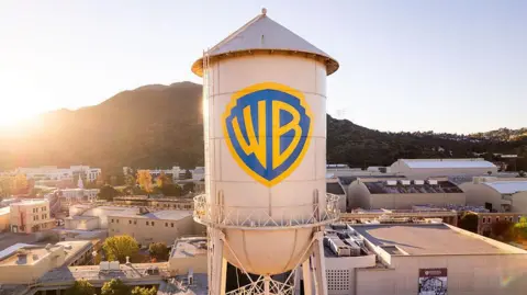 The Warner Bros logo is displayed on the water tower 