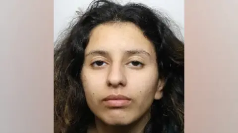 South Yorkshire Police A police mugshot of Paris Askew. She is looking straight at the camera. She has long wavy brown hair and brown eyes.