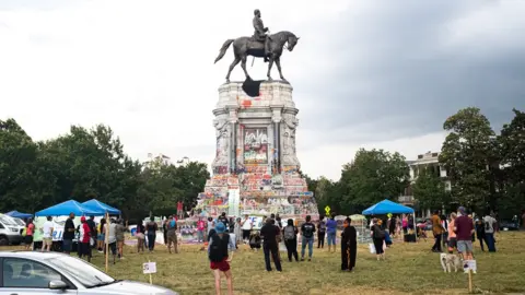 Getty Images Protesters gather at a statue of Confederate Gen Robert E. Lee earlier this year