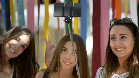 Getty Images Girls take a selfie in Spain
