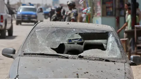 Getty Images The aftermath of a car bombing in the Dora district of Baghdad showing a car with destroyed windscreen