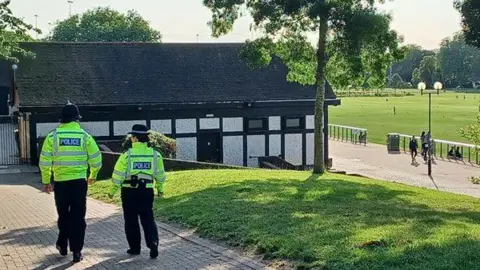 Two uniformed officers walking through Forest Rec