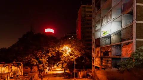 BBC/SHIRAAZ MOHAMED The derelict San Jose building with its window frames removed as seen at 04:30 in Johannesburg, South Africa