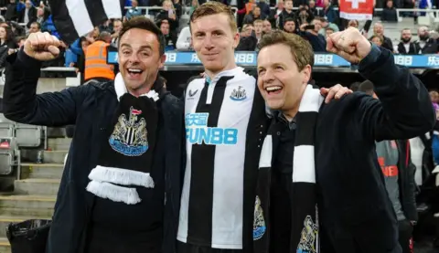 Newcastle United/Getty Images Matt Targett of Newcastle United (13) poses with Ant & Dec after the Premier League match between Newcastle United and Arsenal at St. James Park on May 16, 2022