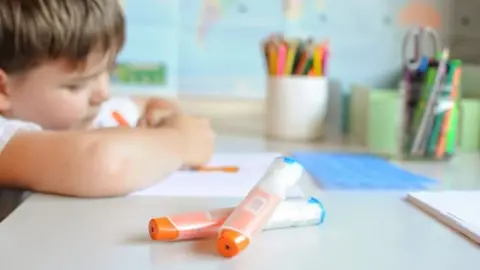 Getty Images Young child with an anaphylaxis injector pen