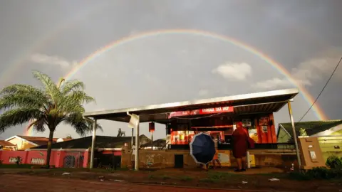 Reuters A rainbow is seen briefly after flooding in Inanda, Durban, South Africa, April 13, 2022.
